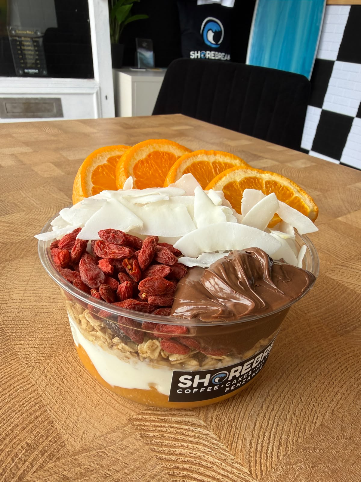 Shorebreak granola bowl with orange, coconut and goji berries