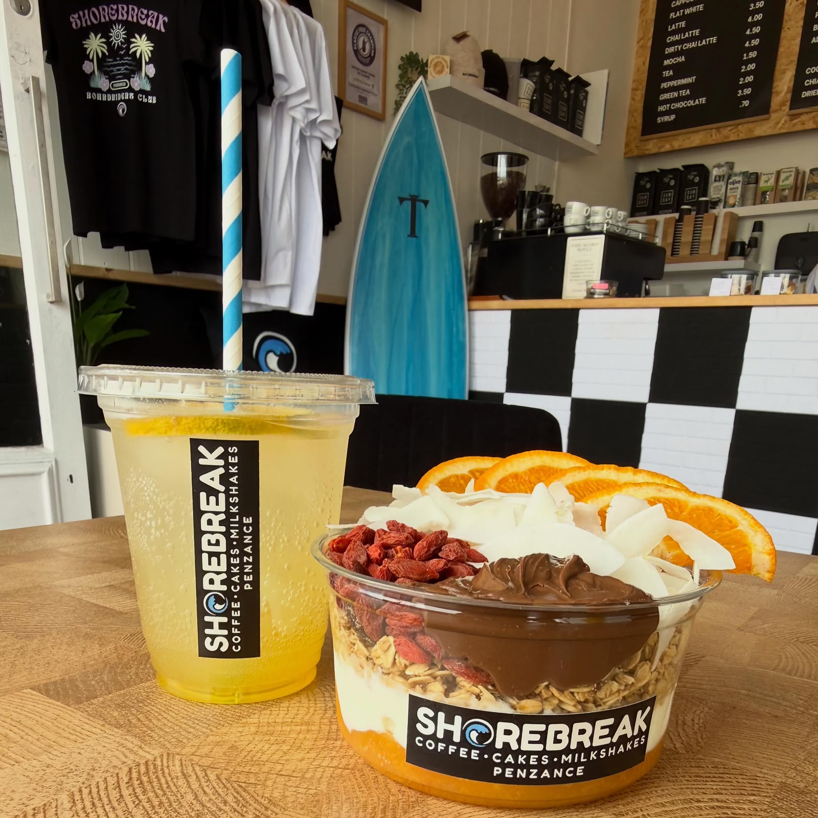 Granola bowl with goji berries, coconut and orange, with fresh juice